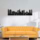ArcDew Boston Skyline Acrylic Wall Art – Modern City Décor - arcdew.com - ArcDew black acrylic Boston skyline wall art with branded special cityscape design above yellow sofa.