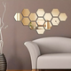 ArcDew Hexagon Acrylic Mirror Wall Decals Decor UAE - arcdew.com - ArcDew special branded hexagon acrylic mirror wall decals in gold finish on brown wall.