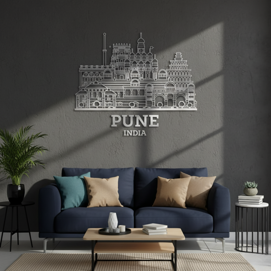 ArcDew: Pune, India City Skyline Wall Art for UAE Homes - arcdew.com - ArcDew branded acrylic Pune India city skyline wall art in silver above navy sofa with cushions.