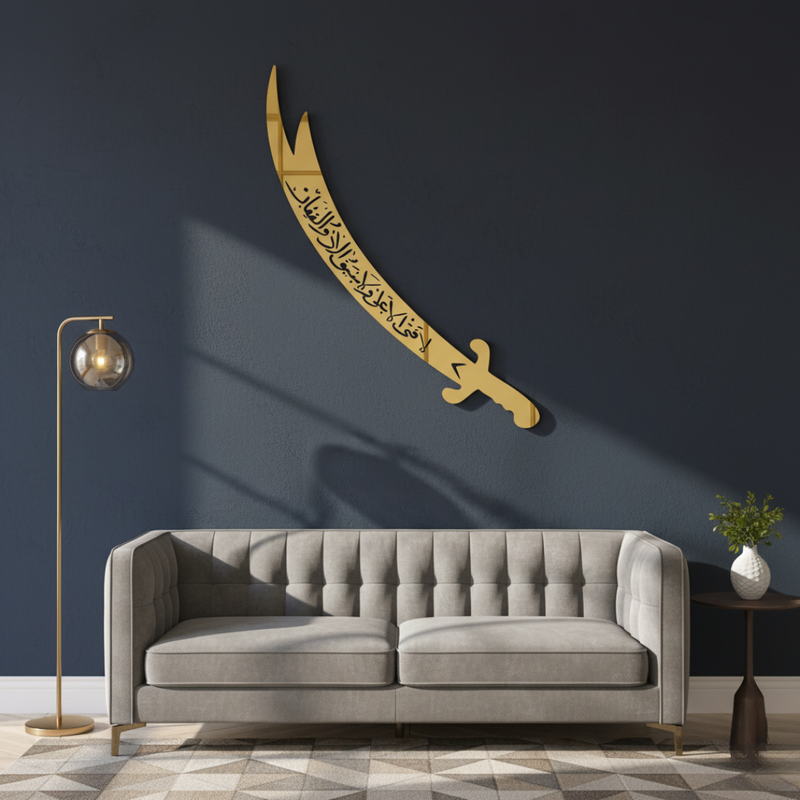 ArcDew Zulfiqar Sword Hazrat Alis Sword Moharram Decal UAE - arcdew.com - Gold acrylic ArcDew Zulfiqar sword wall decal with Islamic calligraphy above gray sofa.