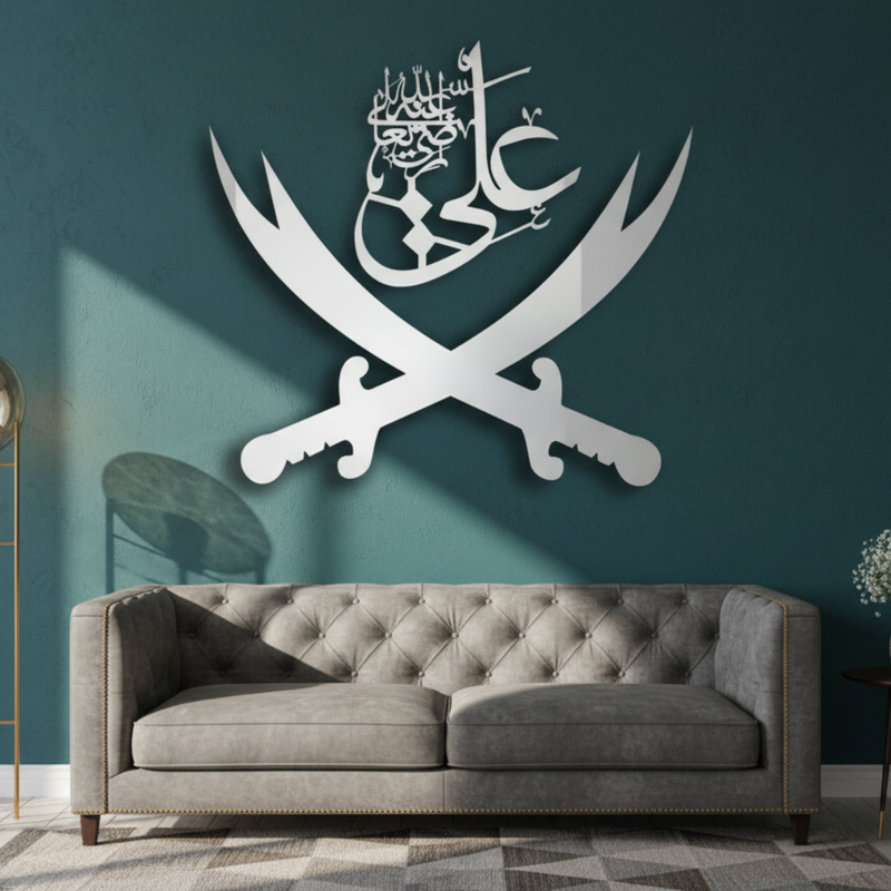 Arcdew Ali Black Sword Islamic Calligraphy Wall Decal | Moharram Acrylic Wall Art - arcdew.com - Arcdew branded black acrylic sword Islamic calligraphy wall decal above gray tufted sofa.
