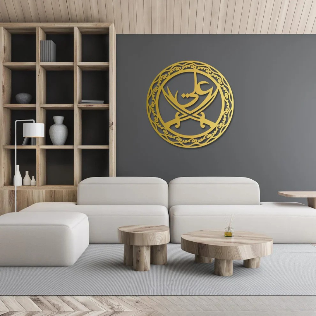 Arcdew Ali Sword Islamic Calligraphy Wall Art | Moharram Acrylic Wall Decor - arcdew.com - Gold Arcdew acrylic Ali sword Islamic calligraphy wall art with intricate circular design on gray wall.