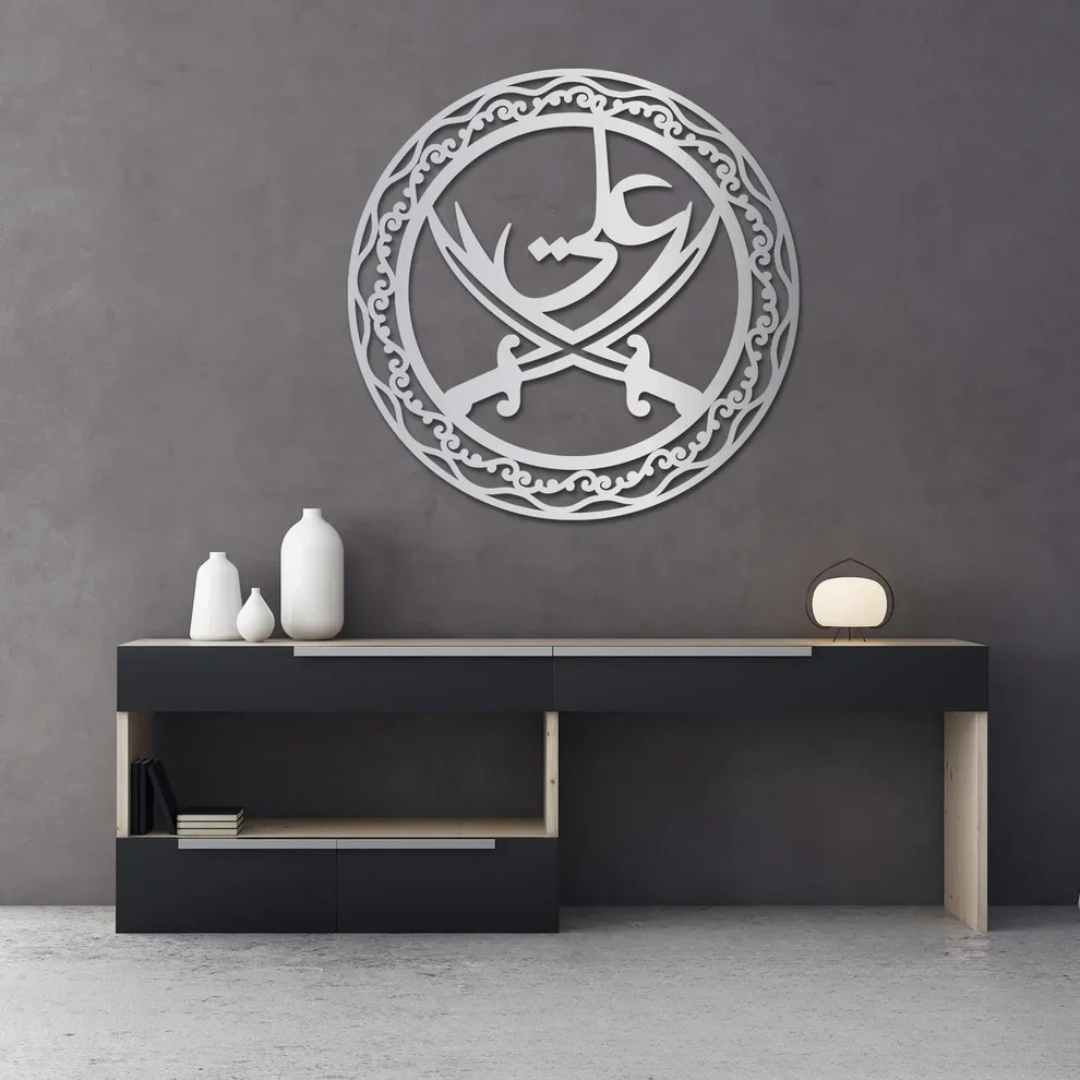 Arcdew Ali Sword Islamic Calligraphy Wall Art | Moharram Acrylic Wall Decor - arcdew.com - Silver acrylic Arcdew Ali Sword Islamic calligraphy wall art with intricate circular design on gray wall.
