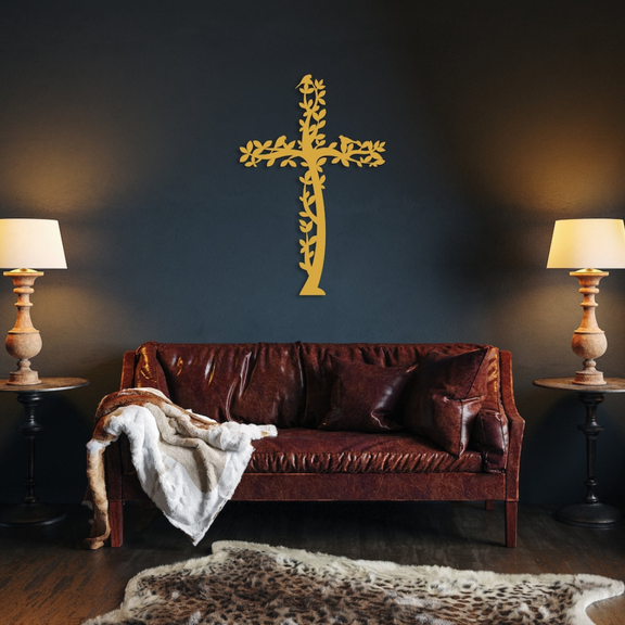 Arcdew Jesus Cross Tree & Birds – Christian Home Décor UAE | Christmas & Baptism Gift for Church & Home - arcdew.com - Gold acrylic Arcdew Jesus cross wall decoration with vine and bird design above brown leather sofa.