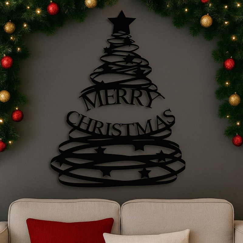 Black 'Merry Christmas' tree decoration on a gray wall with festive lights and greenery.