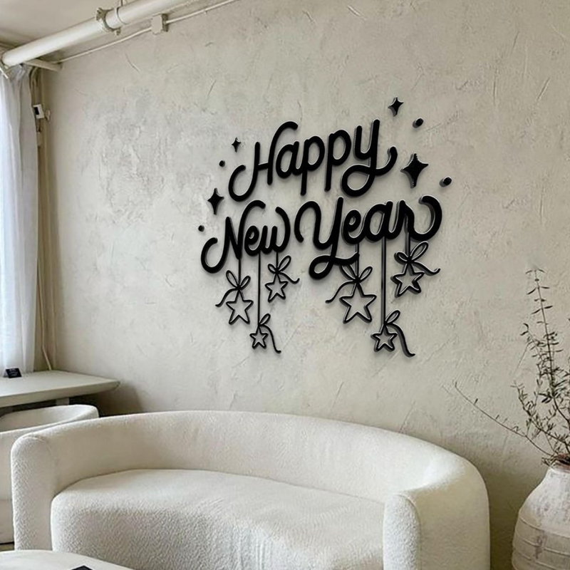 Decorative wall art with 'Happy New Year' text on a plain wall.