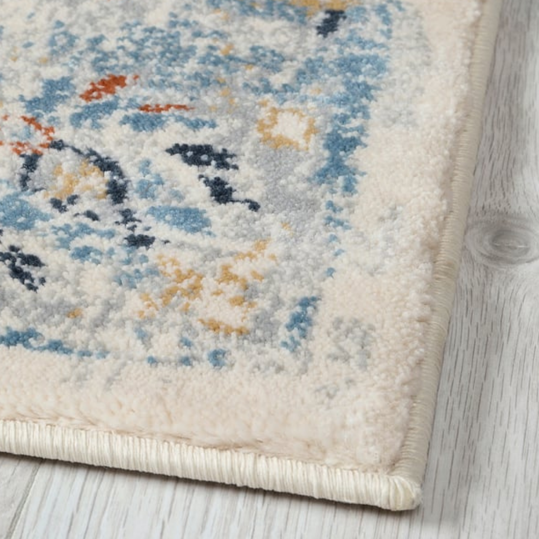 Close-up of a patterned rug on a wooden floor