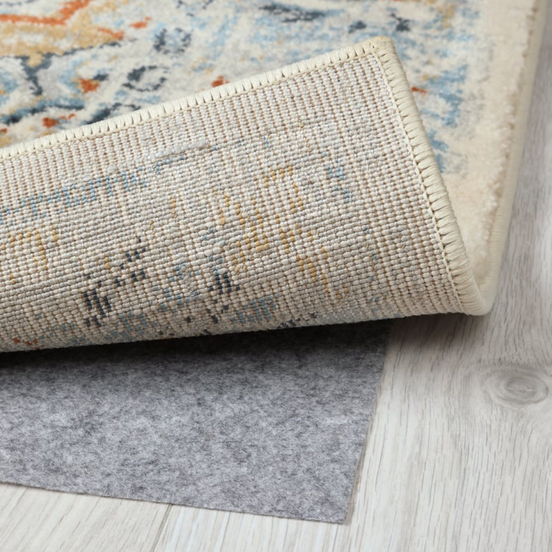 Roll of rug with a textured pattern on a wooden floor