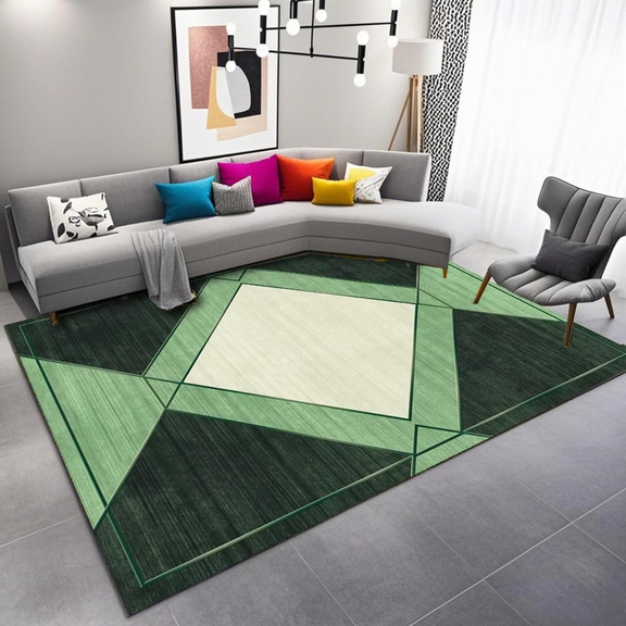 Living room with a green geometric rug, gray sectional sofa, and colorful pillows.