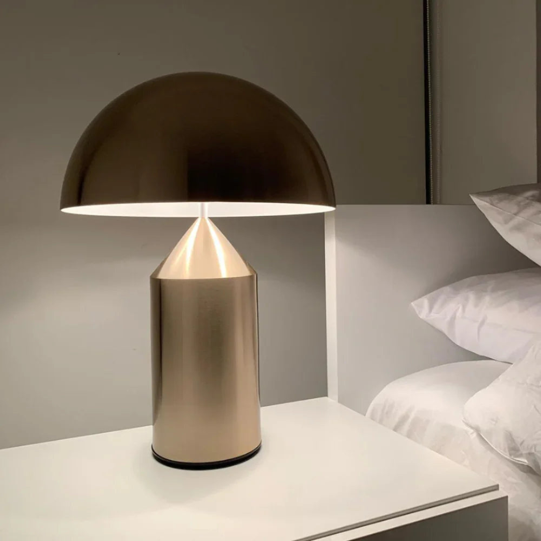 Modern table lamp with a metallic base and black shade on a nightstand.