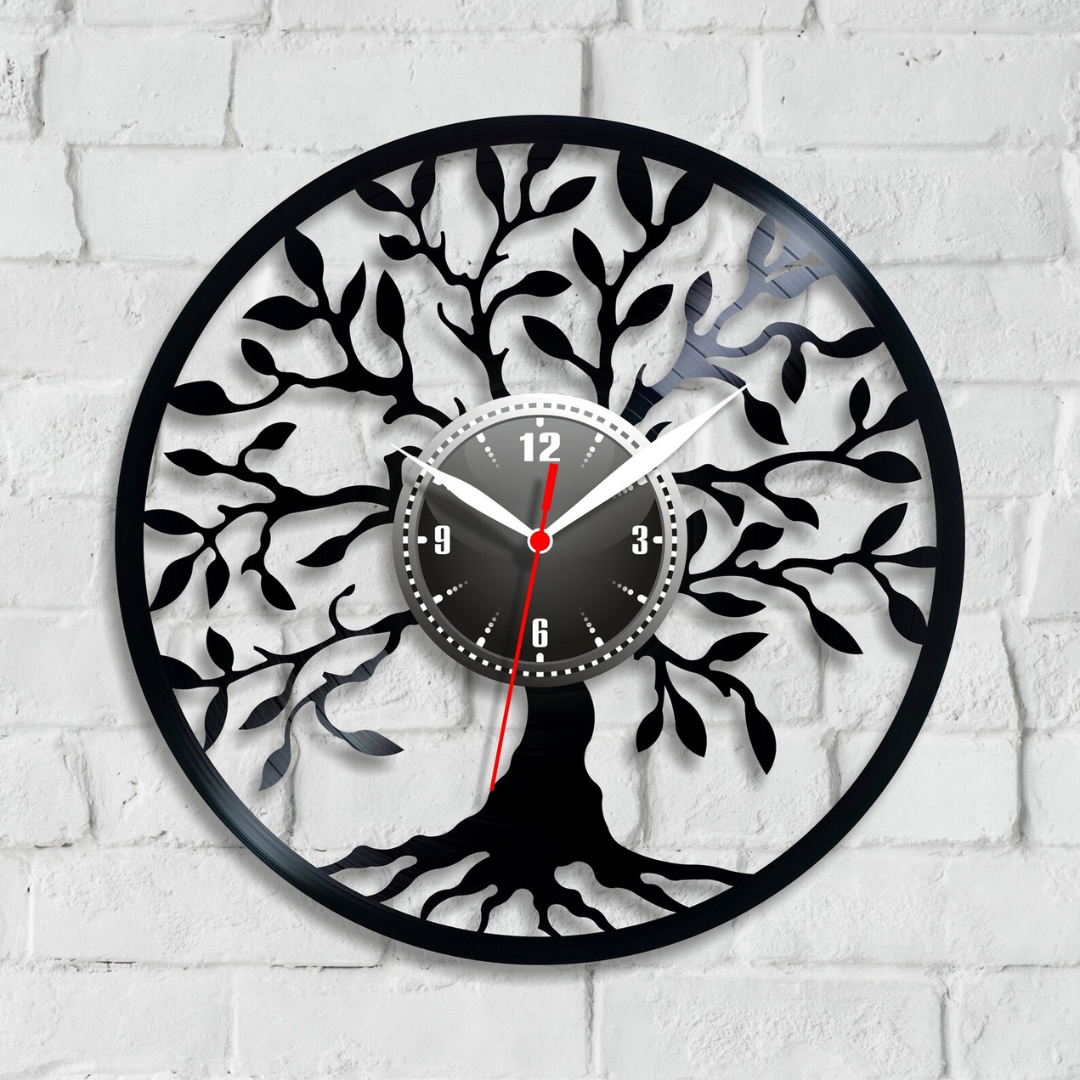 Decorative wall clock with tree design on a white brick wall